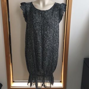 Unique sheer dress with ruffled sleeves and hem